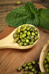 Organic Mung Bean Granules in Wooden Spoon - Healthy Legume Ingredient for Gourmet Cooking