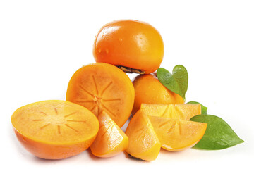 Fresh Persimmon Fruit Sliced and Whole with Green Leaves on White Background