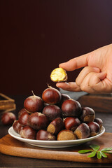 Fresh Roasted Chestnuts with Golden Flesh on Rustic Wooden Table - Autumn Seasonal Food