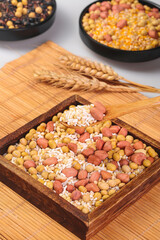 Mixed grains legumes cereals in wooden box with wheat - healthy protein food ingredients collection