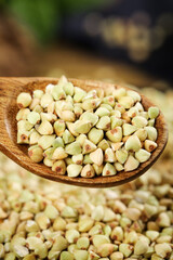 Raw Buckwheat Groats in Wooden Spoon - Healthy Organic Grains Food Ingredient