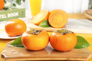 Fresh Ripe Persimmons on Wooden Cutting Board - Healthy Fruit Kitchen Still Life