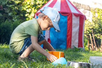 A child is playing in a grassy garden