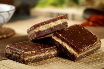 Handmade Brown Sugar Candy Bars with Amber Luster on Wooden Board - Traditional Cane Sugar Confection