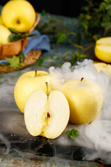 Fresh Yellow Apples on Marble Surface with Dramatic Smoke Effect - Premium Fruit Display