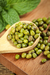 Organic Mung Bean Grains in Wooden Spoon - Healthy Legumes for Gourmet Cooking
