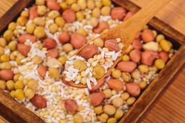 Mixed legumes grains nuts wooden spoon healthy protein sources soybeans peanuts beans nutritious cooking ingredients