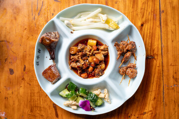Assorted Traditional Cuisine Served on a Divided Round Plate