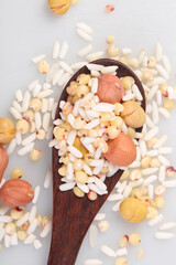 Mixed Grains Nuts and Legumes in Wooden Spoon - Healthy Organic Food Ingredients for Cooking and Nutrition