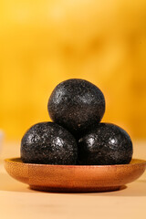 Handmade Black Sesame Balls on Wooden Plate - Nutritious Dietary Snack Food