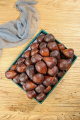 Fresh Snake Fruit Salak in Basket on Wooden Table - Tropical Bali Produce with Natural Textured Skin