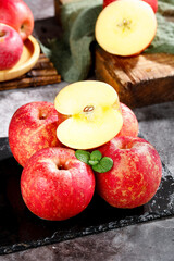 Fresh Yunnan Province Red Apples Sliced on Dark Slate Background with Mint Leaves