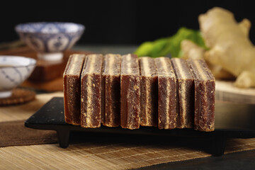 Handmade Brown Sugar Blocks on Slate Board with Asian Kitchen Ingredients for Cooking and Baking