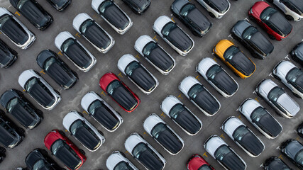 Aerial view car for sale stock lot row, Cars dealership inventory distribution automobile and automotive business, New cars parking for sale automobile automotive industry business. © Kalyakan