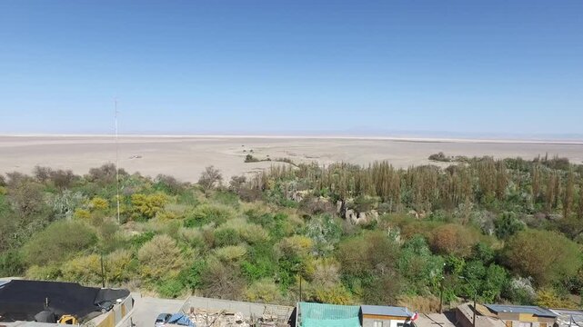 Aerial drone videos of a traditional desert village with colonial church and green oasis in the Atacama Desert, northern Chile