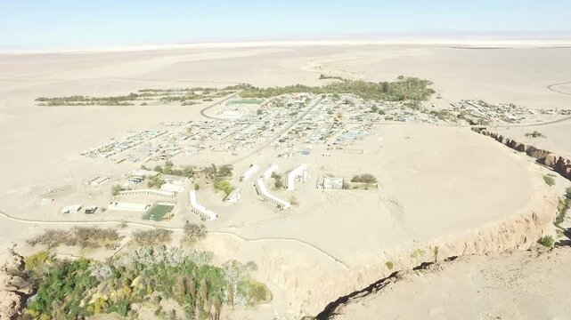 Aerial drone videos of a traditional desert village with colonial church and green oasis in the Atacama Desert, northern Chile