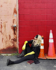 Tired Bored Super Hero Girl Sitting on Ground