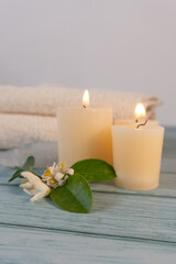 Spa table with candles, towels, and lemon blossoms