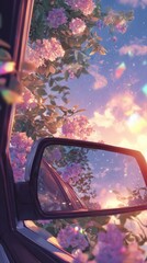 A vibrant sunset reflected in a car's side mirror, framed by blooming pink flowers and shimmering particles