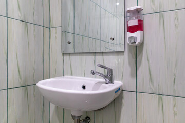 Hand washing facilities with soap and mirror in the bathroom
