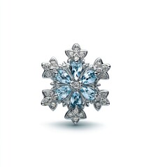 An intricately designed snowflake pendant featuring light blue gemstones and smaller clear stones set in a silver or white metal framework, shown against a white background