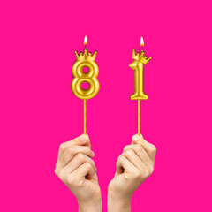 Hands holding number shaped candles - Birthday number 81