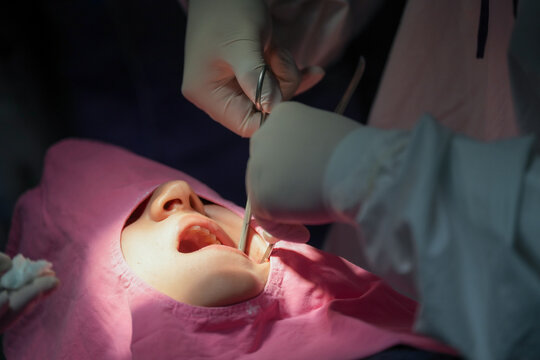 Dentist is checking patient teeth during dental procedure, ensuring thorough examination while patient is comfortably positioned. atmosphere is calm and professional