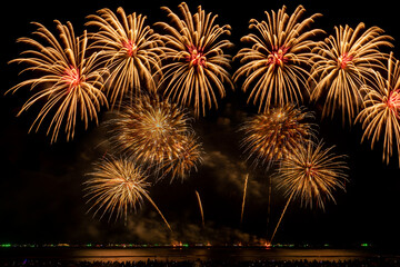 Abstract real golden shining fireworks with bokeh in dark night sky. Celebration glowing fireworks show. 4th independence day and new year background or wallpaper. abstract background , anniversary.