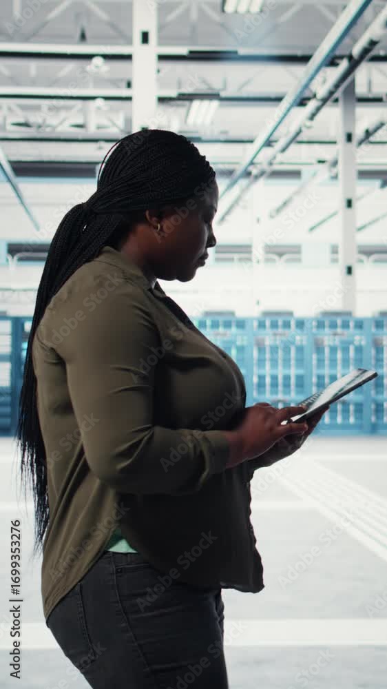 Aufkleber vertical video technician walking in data center with tablet, checking hardware for system stability
