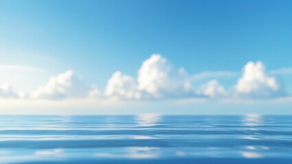 Obraz premium Serene expanse of ocean water meeting a pale blue sky filled with soft, white clouds, displaying a tranquil and peaceful atmosphere.