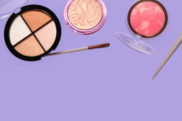 Flying decorative cosmetics on lilac background