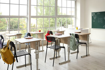 Interior of empty classroom with school desks