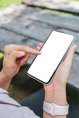 Hand holding smartphone with blank white screen with clipping path for app mockup and mobile design presentation