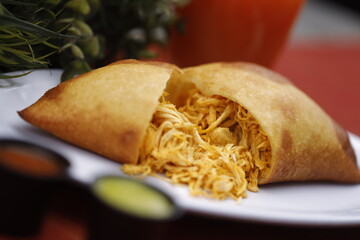 Venezuelan Empanada, sliced open to reveal a generous and colorful filling of shredded chicken 