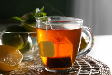Cup of tasty hot tea on table, closeup