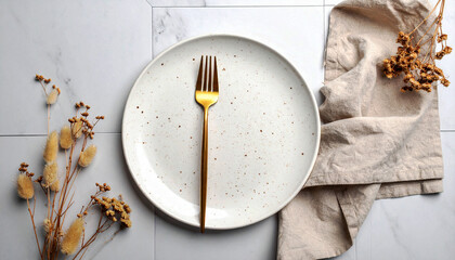 White Speckled Plate with Gold Fork on Marble Surface