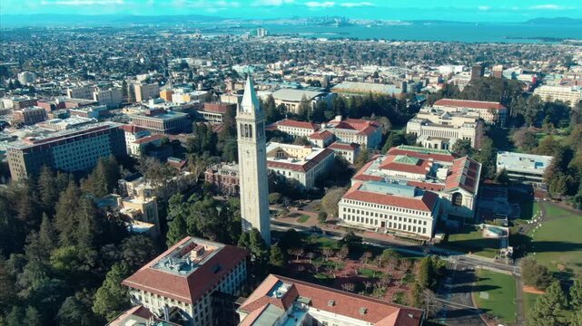 Aerial view of UC Berkeley's iconic Campanile clock tower and campus buildings, showcasing the university's architecture and urban setting in California, USA.