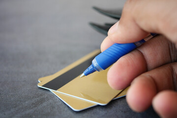 Writing on credit cards at a table