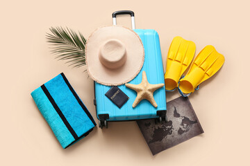 Composition with suitcase, passport, world map and flippers on beige background © Pixel-Shot