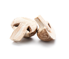 Cut raw champignon mushroom isolated on white background, closeup