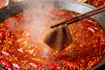 Lifting Beef Tripe from a Spicy Hot Pot