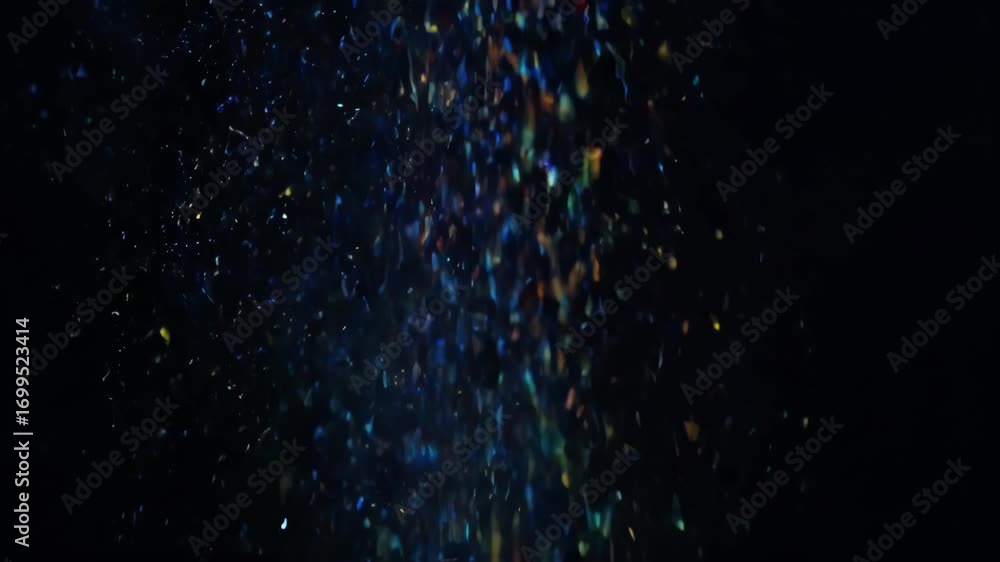 Poster colorful dust particle drifting downward on dark background with glowing light, abstract bokeh spark