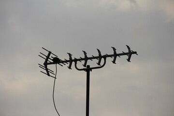television antenna with cloudy sky background