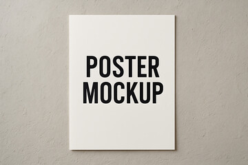 Obraz premium Minimalist white vertical poster mockup on a textured gray wall, an empty framework for showcasing graphic designs, advertising, and corporate branding presentations