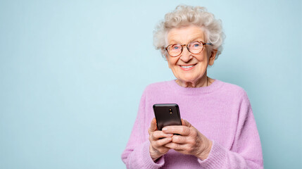 Elderly woman smiling while holding smartphone, plain pastel background, professional portrait.