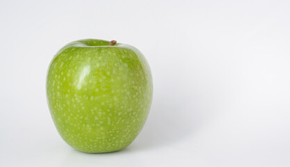 Light background with green apple with spots, with copy space