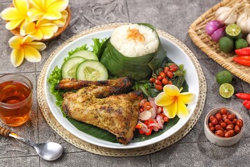 Nasi Ayam Betutu. Betutu Chicken Rice served with plecing kangkung and sambal matah