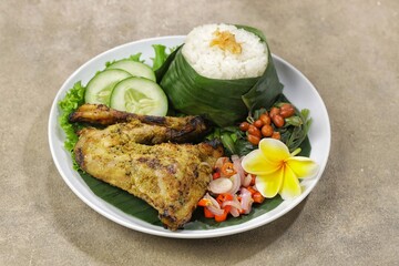 Nasi Ayam Betutu. Betutu Chicken Rice served with plecing kangkung and sambal matah