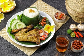 Nasi Ayam Betutu. Betutu Chicken Rice served with plecing kangkung and sambal matah