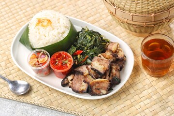 Nasi Ayam Betutu. Betutu Chicken Rice served with plecing kangkung and sambal matah